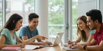 Diverse college students studying with laptops and books in modern library