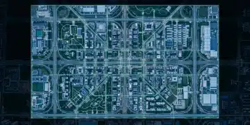 Aerial view of a geometrically structured city at dusk, with glowing green lines overlaying infrastructure, symbolizing evolving public assistance frameworks and interconnected social safety nets.